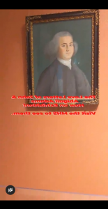 Black bars at the top and bottom of the image surround the beginning of a video–on this still is an orange background with a painting of a young man wearing a gray powdered wig, black vest and jacket with a white shirt and cravat. In red, words read “The Love Letters of John and Abigail Adams, Now on Exhibition! Visit the MHS to see them.”