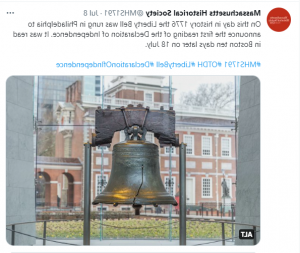 A screenshot of a Twitter post. There is text at the top and an image of a large metal bell with a crack going halfway up the bell. It is suspended between two metal poles holding a wooden board. In the background is a two-story federal style brick building with a statue to the left and a grassy area closer to the bell. 