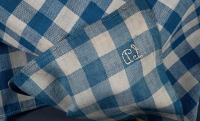 Blue and white checkered fabric, with the initials "LD" embroidered in white